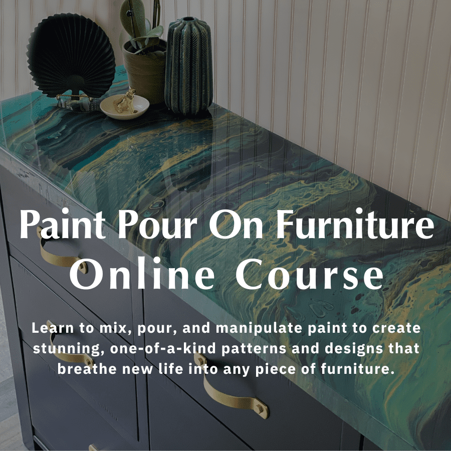 Artistic paint pour on furniture technique on a dresser featuring swirling blue and green hues, complemented by stylish decor accessories.