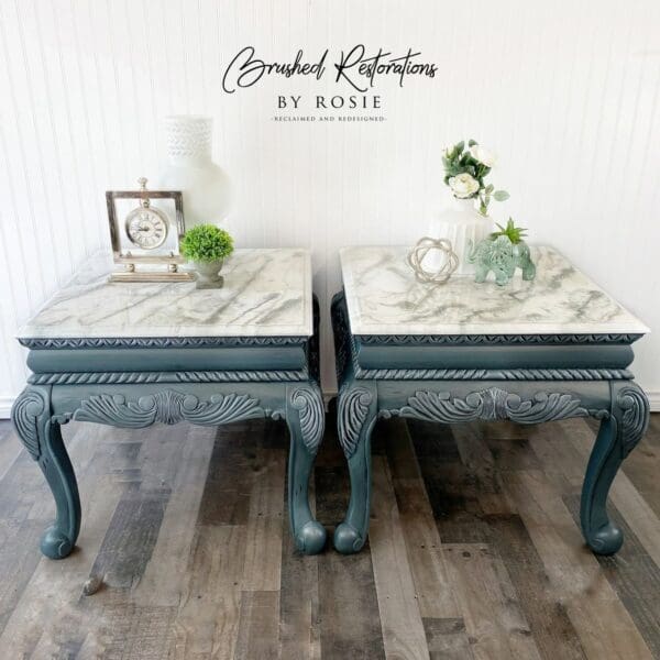 Two tables with marble tops and a clock on the wall.