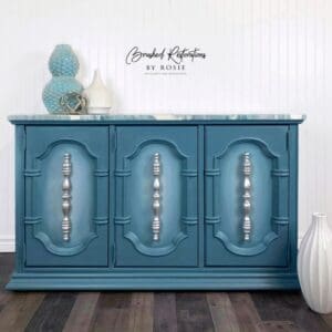 A blue cabinet with three drawers and two doors.