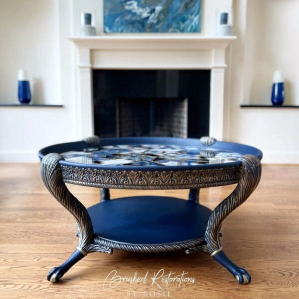 A blue coffee table with a black tray on top of it.