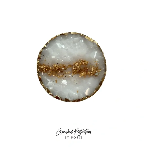 A white and gold round shaped object with the words " stardust reflections by buck."