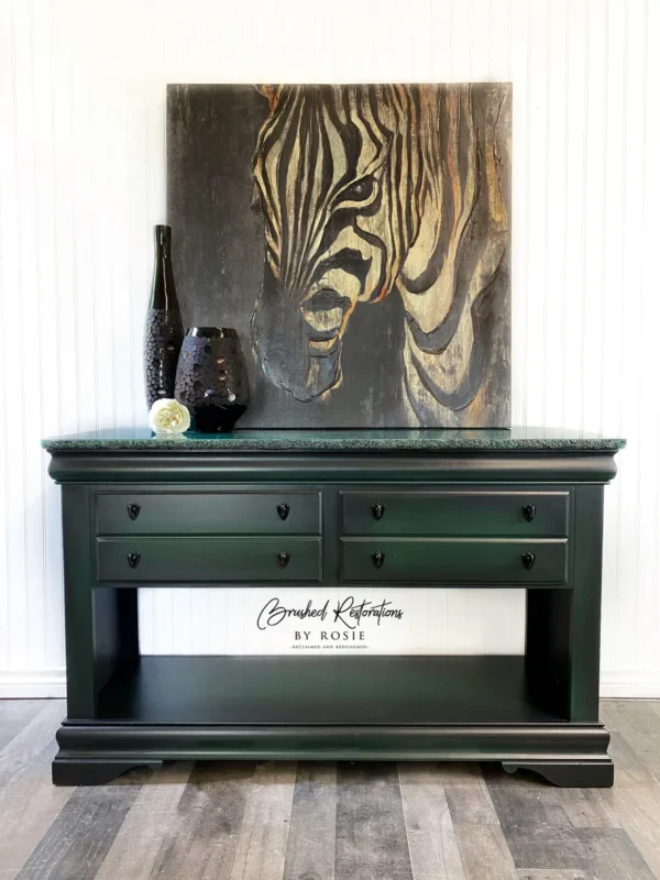 A black table with two drawers and a zebra painting on the wall.