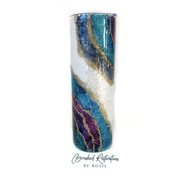 A tall glass vase with blue and purple swirls.