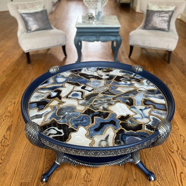 A blue resin art table with a blue and white agate top.