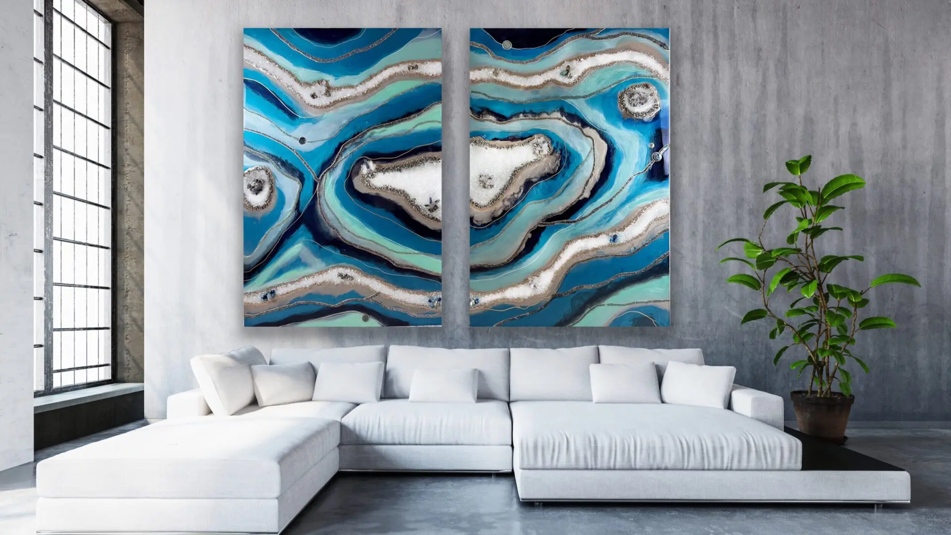 Stunning large-scale triptych geode resin art piece displayed over a contemporary white sectional sofa in a modern living room with industrial-style concrete walls and a large window