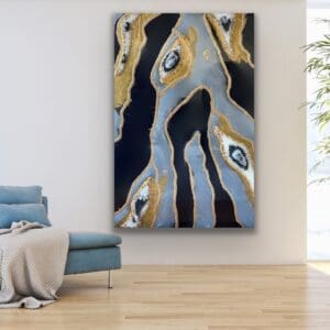 Handcrafted geode resin wall art piece with quartz-like detailing, complementing a cozy blue chaise lounge.