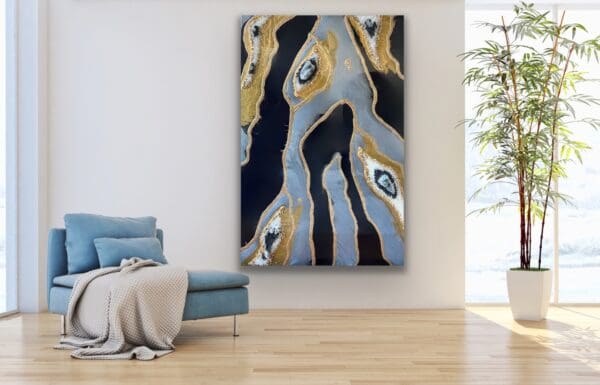 Handcrafted geode resin wall art piece with quartz-like detailing, complementing a cozy blue chaise lounge.