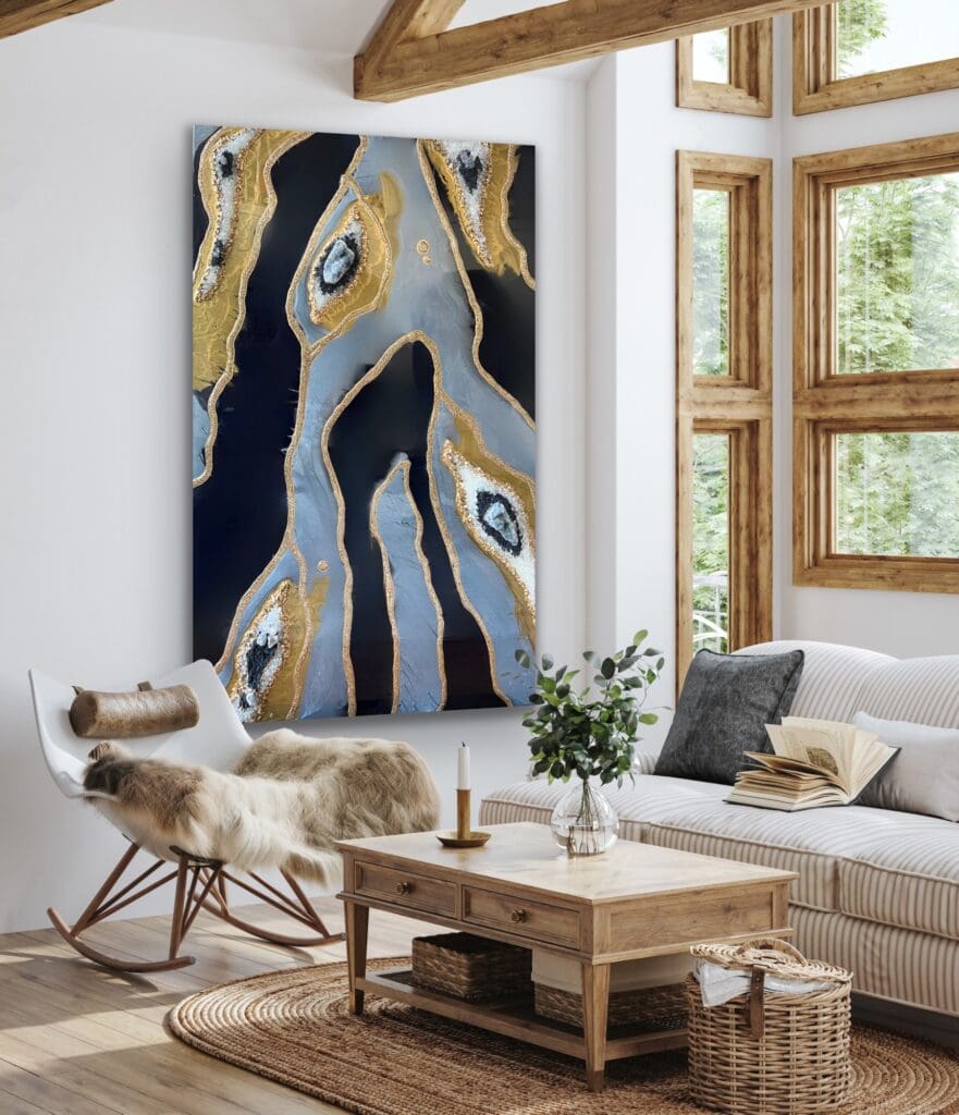 A contemporary living room featuring an original large-scale resin art piece with gold and white accents on a deep blue background, hung on a white brick wall.