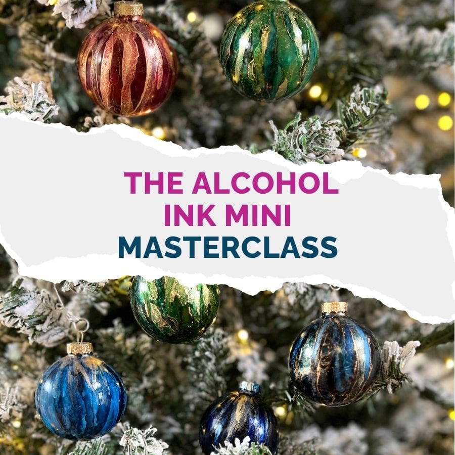 Colorful alcohol ink Christmas ornaments hanging on a frosted tree with text overlay: 'The Alcohol Ink Mini Masterclass' in bold pink and blue lettering.